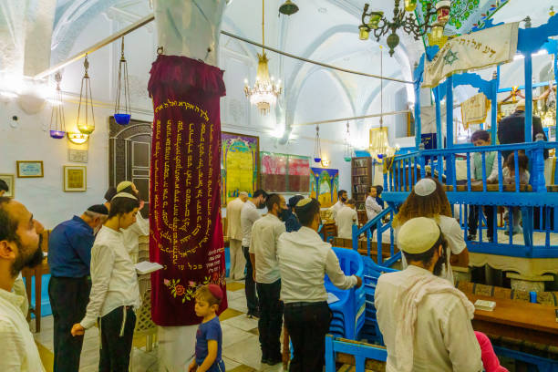 Simchat Torah in the old Abuhav synagogue, Safed (Tzfat) Safed, Israel - September 28, 2021: Jewish people pray, part of Simchat Torah tradition, in the old Abuhav synagogue, the Jewish quarter, Safed (Tzfat), Israel simchat torah photos stock pictures, royalty-free photos & images