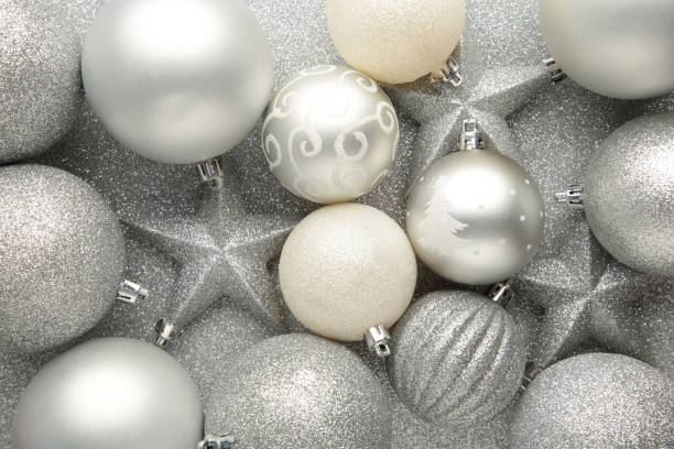 istock Silver christmas baubles background. New Year composition 1344090190