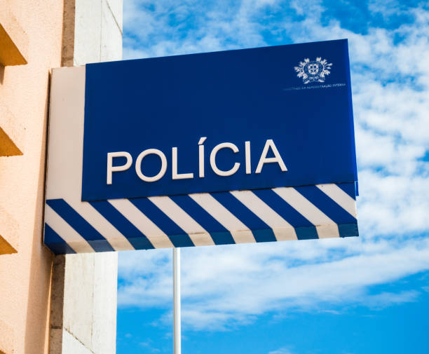Portuguese Polícia / Police sign Cascais, Portugal - A sign on the wall of a police station in the seaside town of Cascais, near Lisbon. psp stock pictures, royalty-free photos & images
