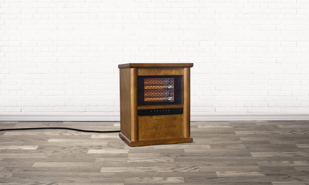 Electrical fireplace in an empty room Electrical fireplace in an empty room with a grey hardwood floor a window space heater stock pictures, royalty-free photos & images