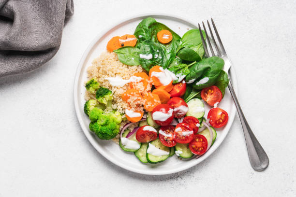 istock Salad with quinoa, spinach, broccoli, tomatoes, cucumbers and carrots 1344091612