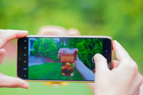 Woman videotaping the brewing of oolong tea