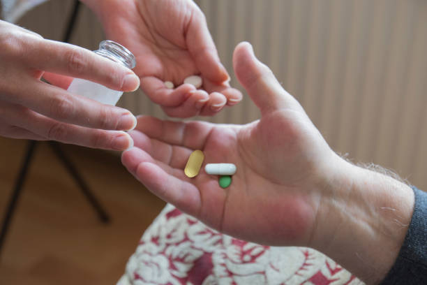 istock doctor giving medicine to old man 1344091683