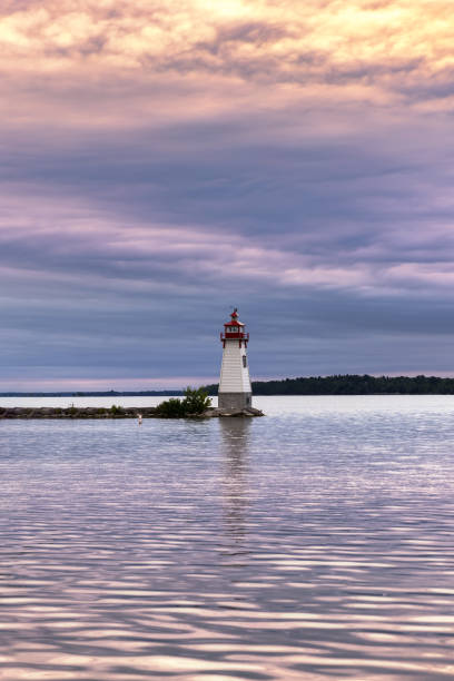 istock Small lighthouse at the end of a rock jetty. Jackson's Point Light 1344092527