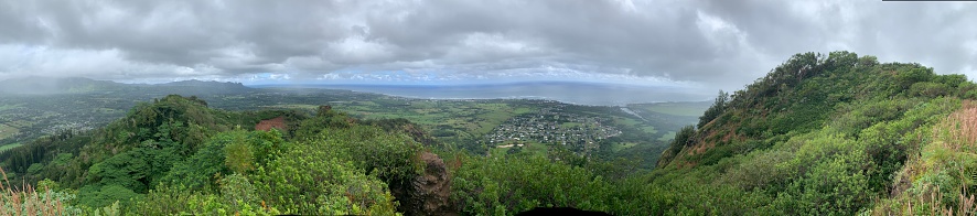 OVERLOOKING KAUAI HAWAII FROM CLIFF WITH CLOUDS AND OCEAN