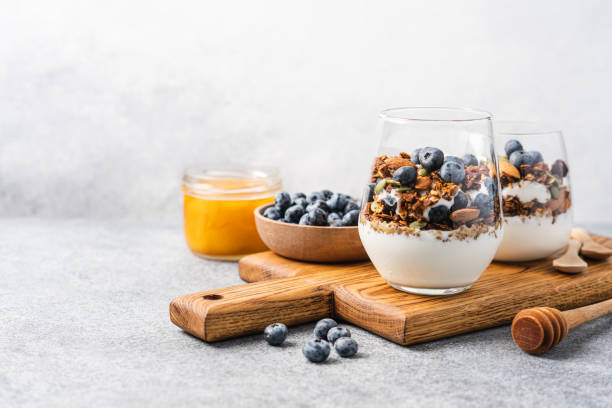 Granola with yoghurt and fresh blueberries Granola with yoghurt and fresh blueberries in glass. Dessert parfait with berries for breakfast granola photos stock pictures, royalty-free photos & images