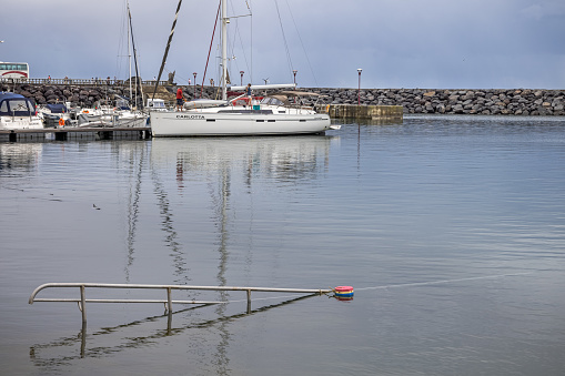 Hand rail in the harbor at high water in the village Povoacao on the south coast of the Portuguese Azorean Island San Miguel in the middle of the North Atlantic Ocean