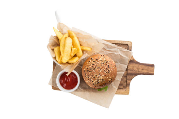 fresh tasty cheeseburger with beef and french fries on woden board isolated on white background stock photo
