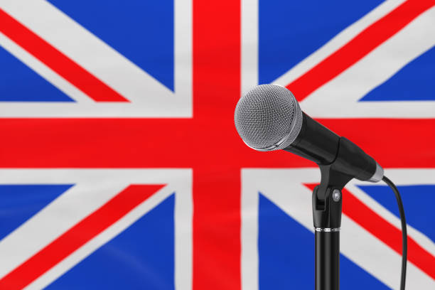 istock Speech Microphone Stand Against of Blurred Great Britain Flag. 3d Rendering 1344095285