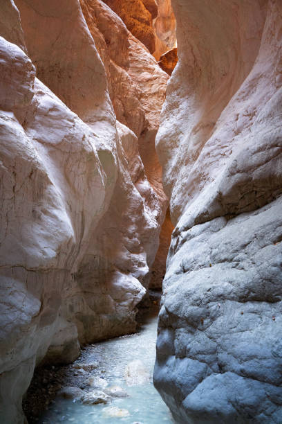 istock vertical canyon entrance with light shining on rocks 1344095289