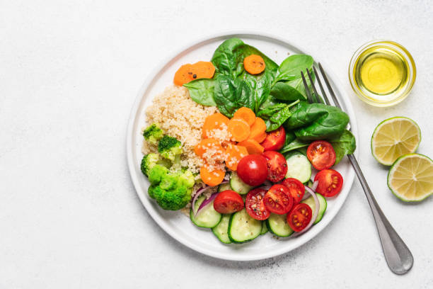 istock Salad with quinoa, spinach, broccoli, tomatoes, cucumbers and carrots 1344095474