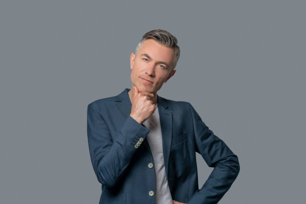 Thoughtful man touching his chin with his hand