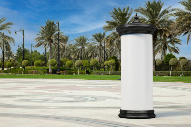 Empty Blank Cylindrical Advertising Column Billboard Mockup with Free Space for Your Design in Empty City Street with Palm Trees. 3d Rendering Empty Blank Cylindrical Advertising Column Billboard Mockup with Free Space for Your Design in Empty City Street with Palm Trees extreme closeup. 3d Rendering advertising column stock pictures, royalty-free photos & images