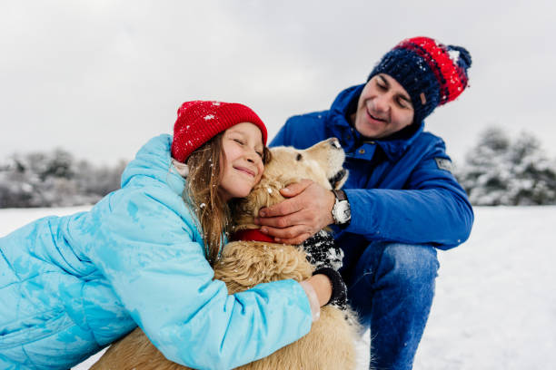 istock On snow with our dog 1344095998
