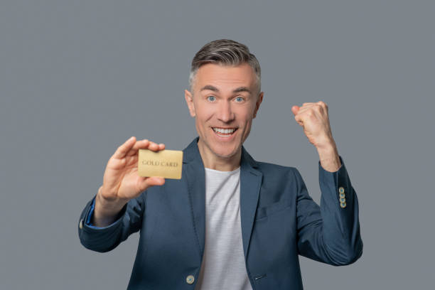 istock Enthusiastic mature man with credit card 1344096895