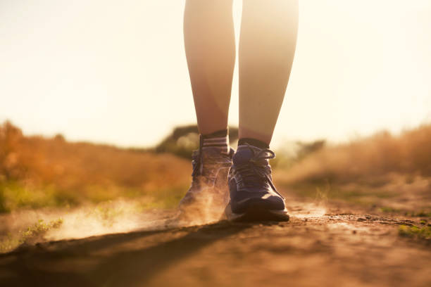istock Female athletic legs and dust from the trail close up. 1344099770