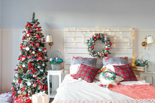 istock Classic interior room with Christmas tree and traditional white red decorations. Modern clean white classical style interior design apartment bedroom. Christmas eve at home. Minimalist home design 1344101084