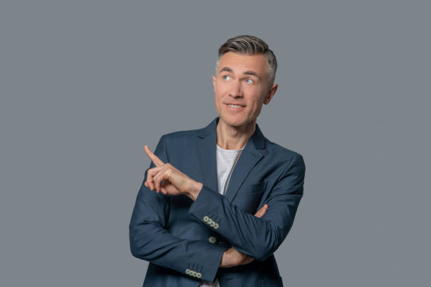 istock Man pointing his finger up and to side. 1344102100
