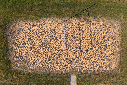 Drone photograph of a community sand volleyball court.
