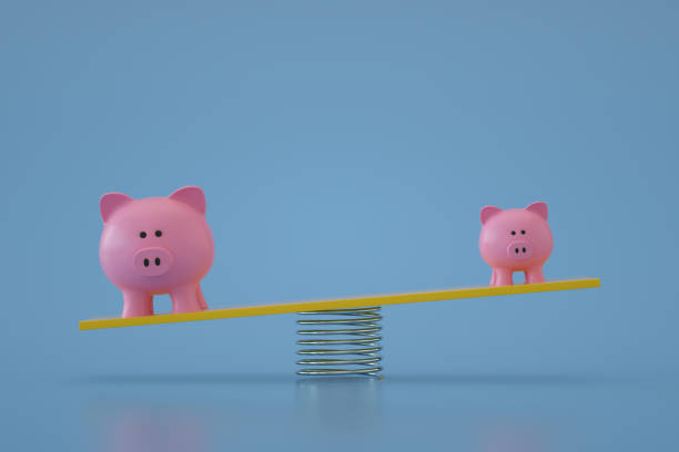 istock Piggy Bank on Balance Board 1344102603