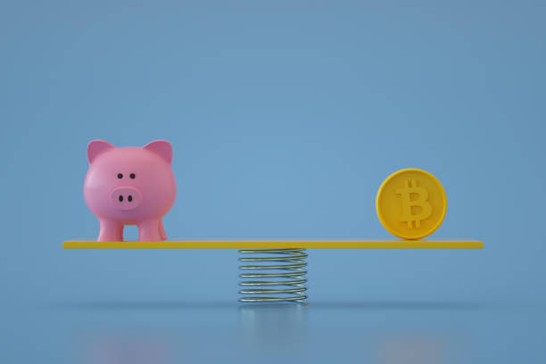 istock Piggy Bank with Bitcoin on Balance Board 1344102786