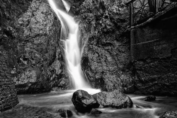 Photo of waterfall among the rocks on a long exposure black and white