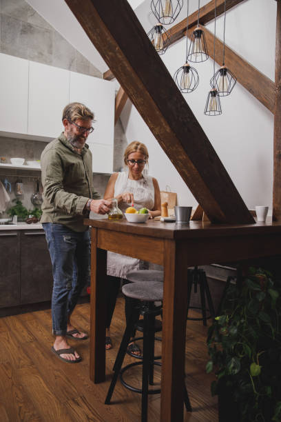 istock Mature couple working together on preparing a dinner in the kitchen 1344106038