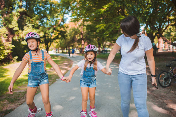istock Girls ride rollerblades with their mother 1344109681