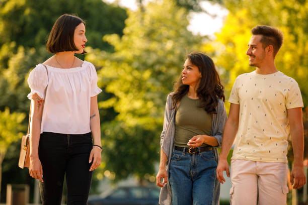 istock Couple going on a walk with a friend, chatting together 1344109802