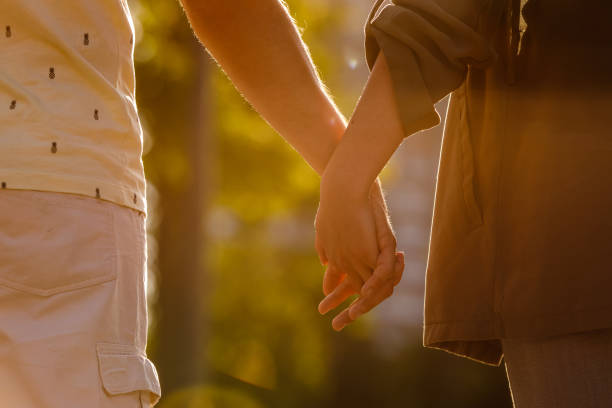 istock Rear view of couple holding hands on a walk 1344109913