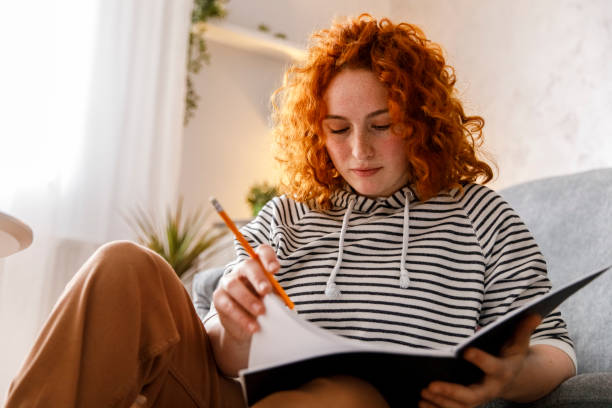 istock Young female university student studying at home 1344111159