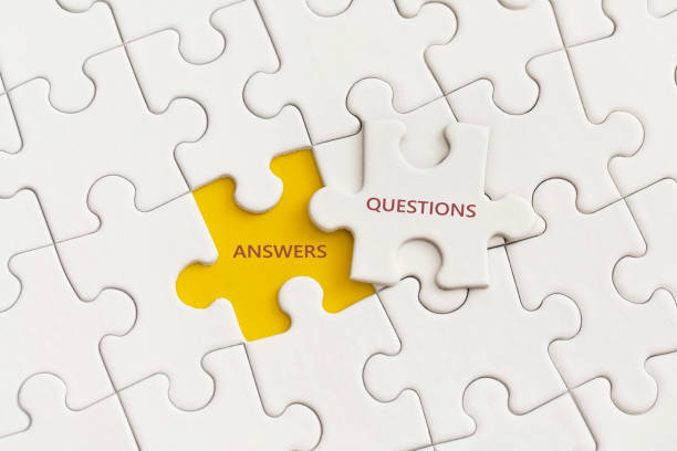 istock White details of puzzle with the text Answer and Question on yellow background. 1344111333