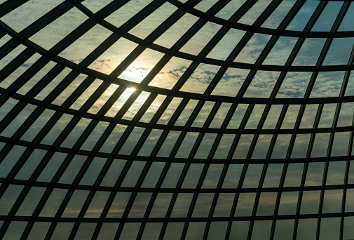 Window roof view of cloudy sky with strong sun in background good for background.