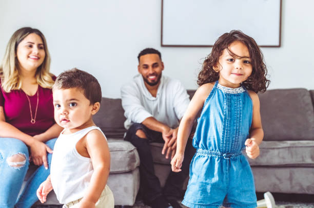 istock Parents at home with two wild and energetic small children 1344113897