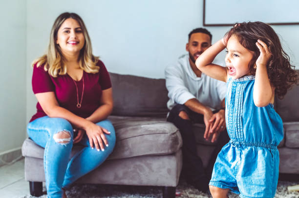 istock Wild energetic kid at home with her two parents 1344113997