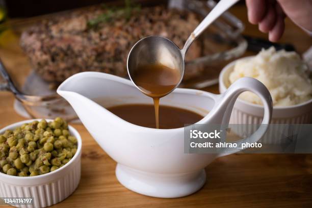 Gravy Sauce In Sauce Pod With Mashed Potato Stock Photo - Download Image Now - Gravy, Brown, Preparation
