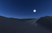desert landscape of dunes with full moon