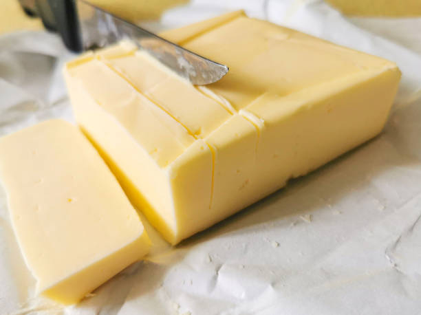 istock Sliced ​​butter pieces with knife on a table 1344117397