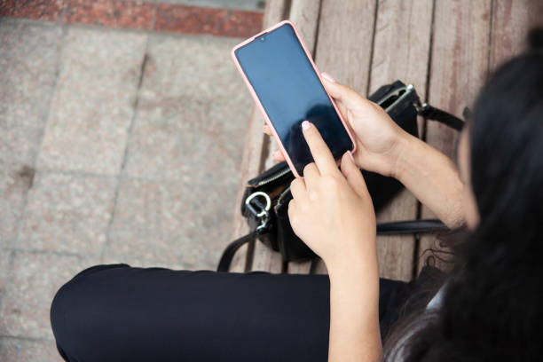 istock woman hand phone on the stairs 1344118428