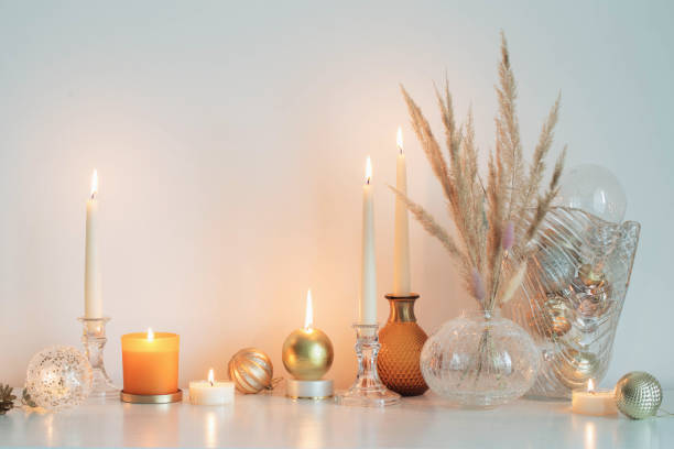 istock christmas decorations with burning candles in white room 1344119658