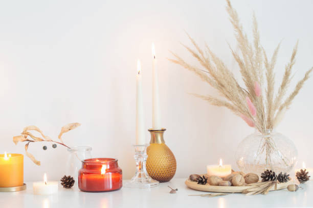 istock autumn home decorations with burning candles 1344119862
