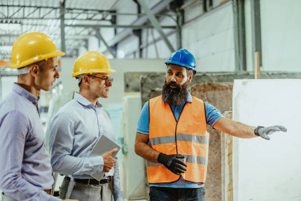 istock Colleagues talking and checking supplies in factory warehouse 1344120936
