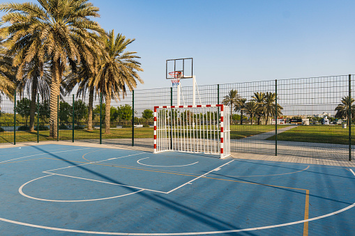 Bright blue soccer and basketball court outside for children sports and recreation.