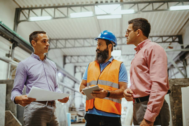 istock Employees in factory - white collar and blue collar workers 1344121585
