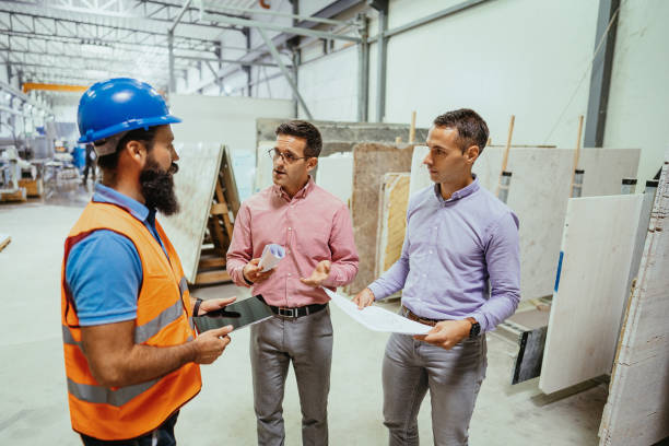 istock Engineer showing blueprints to colleagues on construction site 1344122489