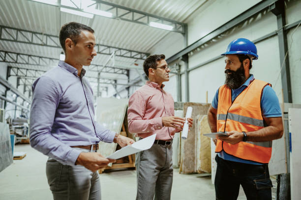 istock Engineer showing blueprints to colleagues on construction site 1344122526