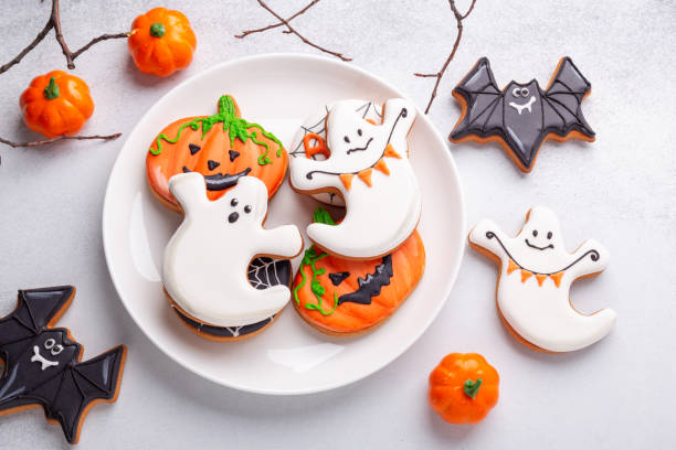 istock Various Halloween gingerbread cookies on white plate on stone background. Bright homemade cookies for Halloween party 1344122903