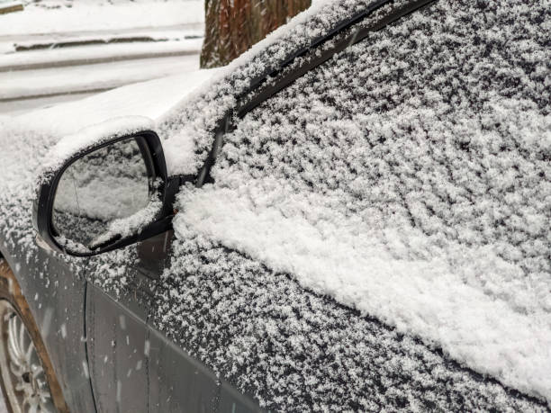 istock Left rear view mirror and side window of the car covered with snow 1344123587