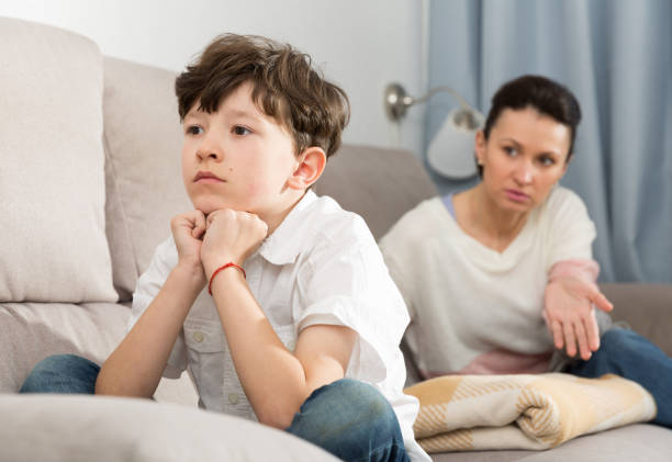 istock Troubled boy and mother scolding him 1344124074