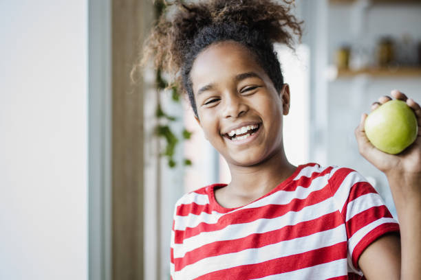 istock Cute girl holding an apple 1344126498